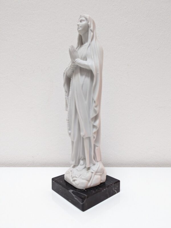 Statue of Our Lady of Lourdes in white marble dust